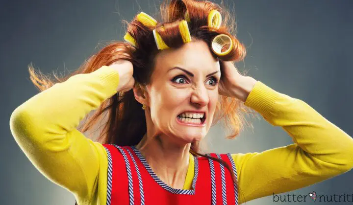 Crazy housewife with curlers isolated on gray