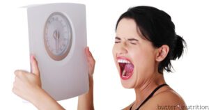 Frustrated woman with scale